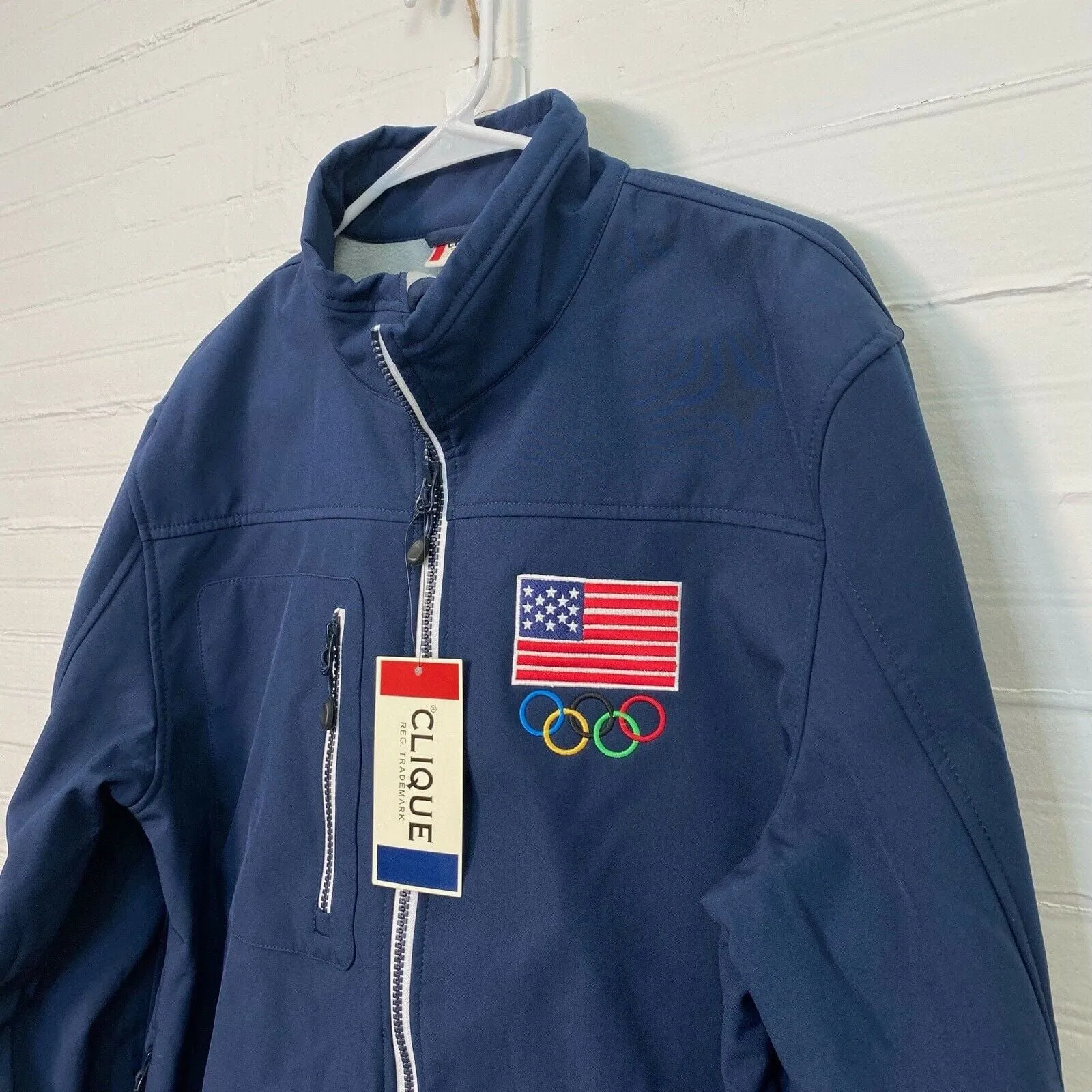 Clique Mens Olympics Jacket | Size Medium | Blue | American Flag & Olympic Rings | “Hershey” Logo | NWT